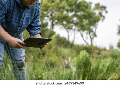 taking a soil sample for a soil test in a field. Testing carbon sequestration and plant health in Australia