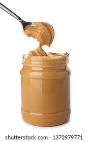 Taking of tasty peanut butter from jar on white background