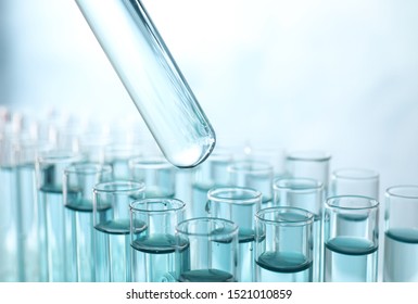 Taking Test Tube With Liquid Sample On Light Background, Closeup