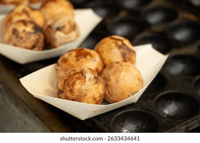 Takoyaki - traditional Japanese street food, Osaka outdoor snack with octopus Takoyaki fried balls, delicious squid dumplings