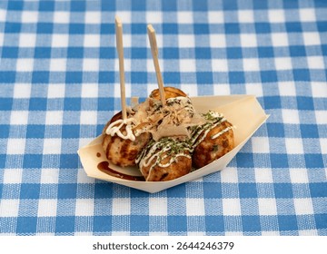 Takoyaki - traditional Japanese street food, outdoor snack with octopus Takoyaki fried balls, delicious squid dumplings