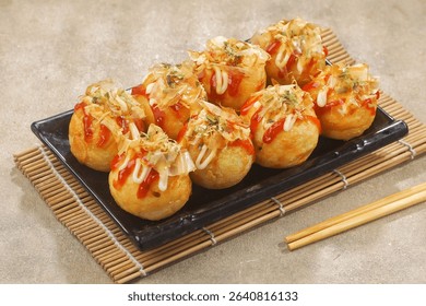 Takoyaki is a typical Japanese snack in the form of small balls made from wheat flour dough and filled with pieces of octopus.