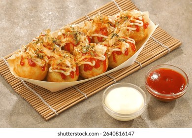 Takoyaki is a typical Japanese snack in the form of small balls made from wheat flour dough and filled with pieces of octopus.