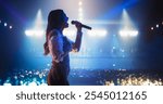 Talent Show Performance: Portrait of a Young Female Pop Singer on a Stage with Colorful Neon Lighting. Musician Singing a Powerful Solo, Poring Her Heartfelt Emotions into Beautiful Music