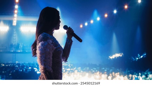 Talent Show Performance: Portrait of a Young Female Pop Singer on a Stage with Colorful Neon Lighting. Musician Singing a Powerful Solo, Translating Her Heartfelt Emotions into Beautiful Music - Powered by Shutterstock