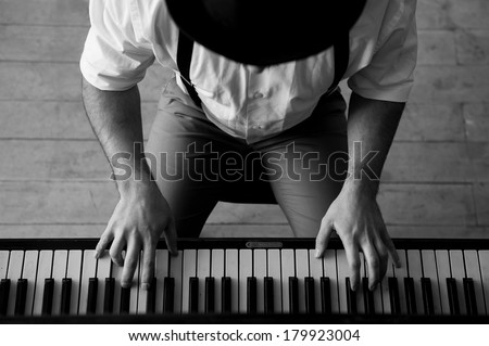Talent and virtuosity. Black and white top view image of man playing piano