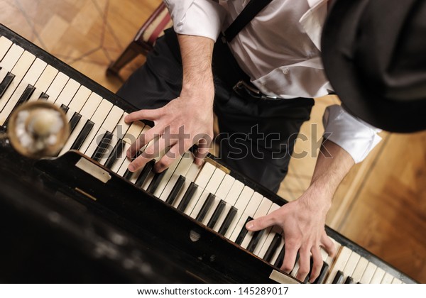 Talent and virtuosity. Top view of handsome young\
men playing piano