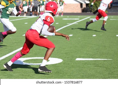 Talented Athletic Young Men Of High School Age Playing Tackle American Football On A Turf Field.