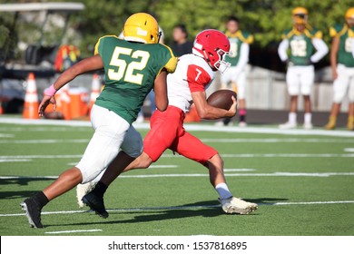 Talented Athletic Young Men Of High School Age Playing Tackle American Football On A Turf Field.