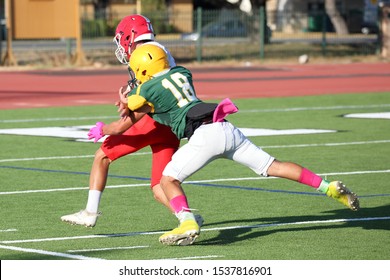 Talented Athletic Young Men Of High School Age Playing Tackle American Football On A Turf Field.