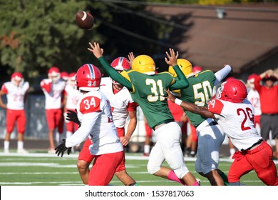 Talented Athletic Young Men Of High School Age Playing Tackle American Football On A Turf Field.