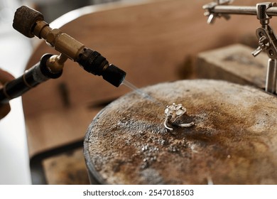 A talented craftsman skillfully shapes a stunning jewel ring in a creative workshop setting. - Powered by Shutterstock