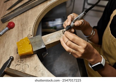 The talented craftsperson carefully shapes metal into an exquisite jewel, showcasing artistry. - Powered by Shutterstock