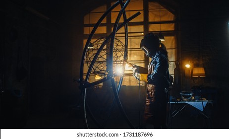 Talented Emerging Female Artist is Welding an Abstract, Brutal Metal Sculpture that Reflects the Present Moment. Beautiful Tomboy Fabricator in Checkered Shirt Creating Modern Steel Art. - Powered by Shutterstock