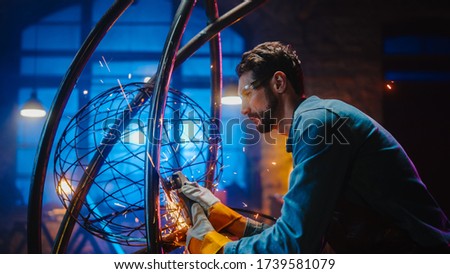 Talented Emerging Male Artist Uses an Disc Grinder to Make an Abstract, Brutal Metal Sculpture that Reflects the Present Moment. Handsome Man Fabricator Creating Modern Steel Art.