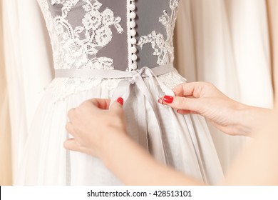 Talented fashion designer is fixing wedding dress - Powered by Shutterstock