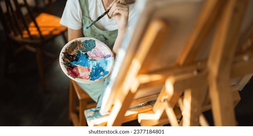 Talented Female Artist Working on a artist lifestyle. painting hobby. woman drawing beautiful watercolor design - Powered by Shutterstock