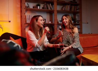 Talented Girls With Beautiful Voices Sit At Home And Sing A Duet At Karaoke Night.