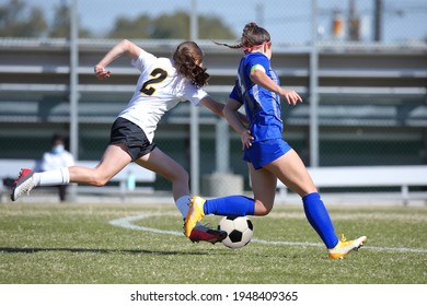 Talented High School Teen Girl Athlete Playing A Competitive Varsity Or Club League Game Of Soccer, Or Futbol, On A Grass Field