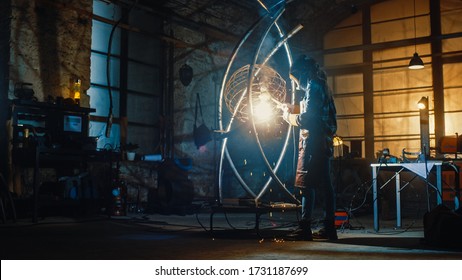 Talented Innovative Tomboy Female Artist in a Checkered Shirt is Welding an Abstract, Brutal and Expressive Metal Sculpture in a Workshop. Contemporary Fabricator Creating Modern Steel Art. - Powered by Shutterstock