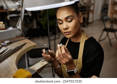 A talented jeweler focuses intently on creating a stunning piece with precision tools. - Powered by Shutterstock