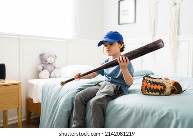 Talented kid preparing for baseball practice. Cute boy with a baseball bat dreaming of becoming a baseball player