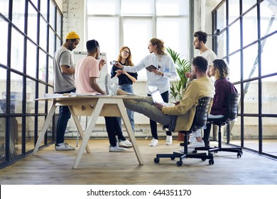 Talented male   female graphic designers having discussion about starting project developing successful strategy planning working in friendly atmosphere  dream team having brainstorming session