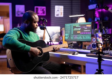 Talented performer teaching how to play acoustic guitar online for a tutorial, hosting internet master class lessons to provide advice for beginners. Artist composer explaining accords on strings. - Powered by Shutterstock