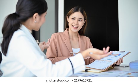 A Talented And Smart Young Asian Female Financial Analyst Or Accountant Presenting Her Financial Investment Plan To Her Female Boss In The Meeting.