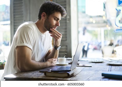 Talented Student Of Design Faculty Of University Thinking Over New Ideas Using Modern Laptop And Wireless Internet In Cafe Indoor For Creating Own Startup Based On Innovative Forecasting 