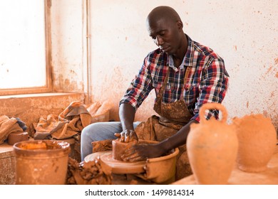 Talented Young African Potter At His Own Pottery Studio Working On New Unique Items 