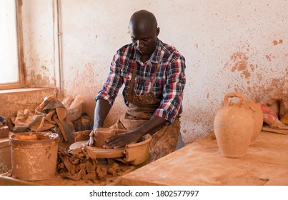 Talented Young African Potter At His Own Pottery Studio Working On New Unique Items