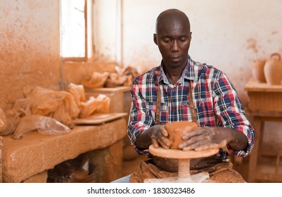 Talented Young African Potter At His Own Pottery Studio Working On New Unique Items