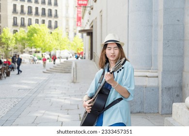 Talented Young Street Musician Captivating Audience with Guitar Performance in Urban Setting