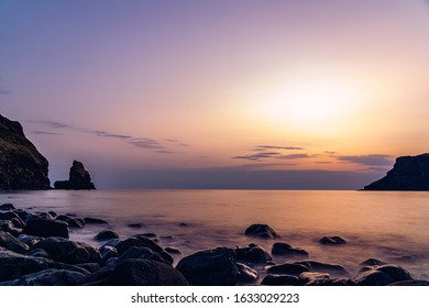 talisker bay at dramatic sunset ocean rocks evening