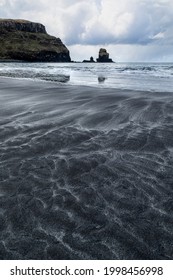 Talisker bay isle of sky with patterns in sand vertical format