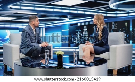 Talk Show TV Program: Two Professional Presenters Talk, Discuss News, Politics, Science, Gossip, Celebrity and Entertainment. Cable Channel Hosts Have Conversation. Mock-up Television Studio.