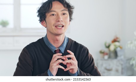 Talking Asian man in the room. Video conferencing. Web meeting. Interview. - Shutterstock ID 2153142363
