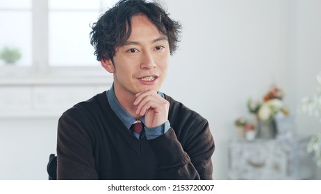 Talking Asian man in the room. Video conferencing. Web meeting. Interview. - Shutterstock ID 2153720007