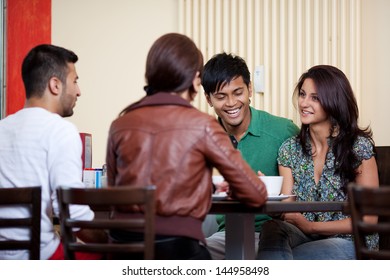 Talking in a coffee shop between good friends - Powered by Shutterstock