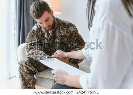 Talking to doctor. Soldier have therapy session with psychologist indoors.