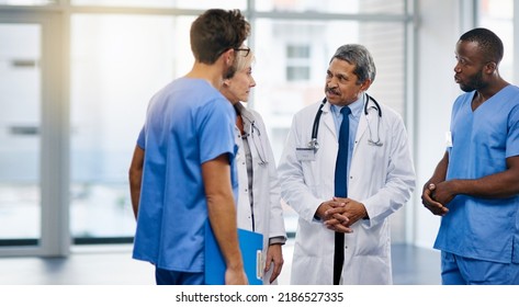 Talking doctors, medical professionals and healthcare workers planning or brainstorming hospital medicine treatment. Diverse group of frontline clinic colleagues discussing new breakthrough in virus - Shutterstock ID 2186527335