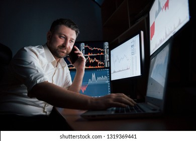 Talking To The Family And Friends. Bearded Man In White Shirt Have A Business Call And Works In The Office With Multiple Computer Screens In Index Charts.