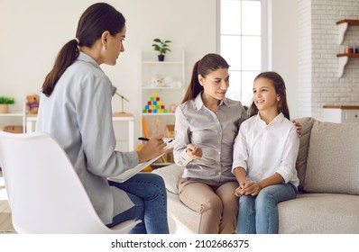 Talking is key to understanding. Parent and child seeing psychologist together. Counseling therapist and mother listening to preteen daughter sharing school news, telling story and answering questions - Shutterstock ID 2102686375