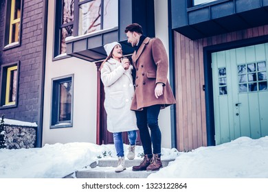 Talking At Man. Happy Girlfriend Holding Coffee Talking To Her Handsome Man While Leaving Private House