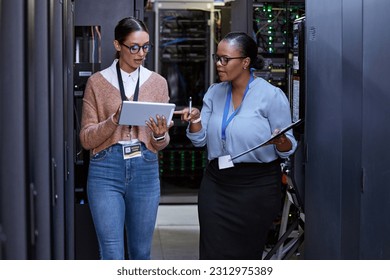 Talking, server room and women with a tablet for cyber security, database planning and inspection. Teamwork, technician and female programmers speaking with technology for coding, hardware and system