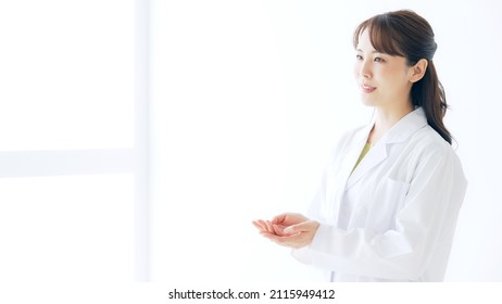 Talking young Asian woman wearing white robe. Interview. Presentation. - Powered by Shutterstock