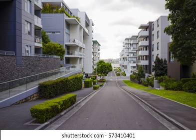 Tall Apartment Block In Sydney, Australia. Tree And Street Light In Front Of A New Apartment Building. Looking Up At A Modern High-rise Apartment House.