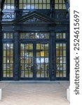 Tall black doors with windows at the entrance of the Hawaii State Library in downtown Honolulu Hawaii USA