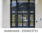 Tall black doors with windows at the entrance of the Hawaii State Library in downtown Honolulu Hawaii USA